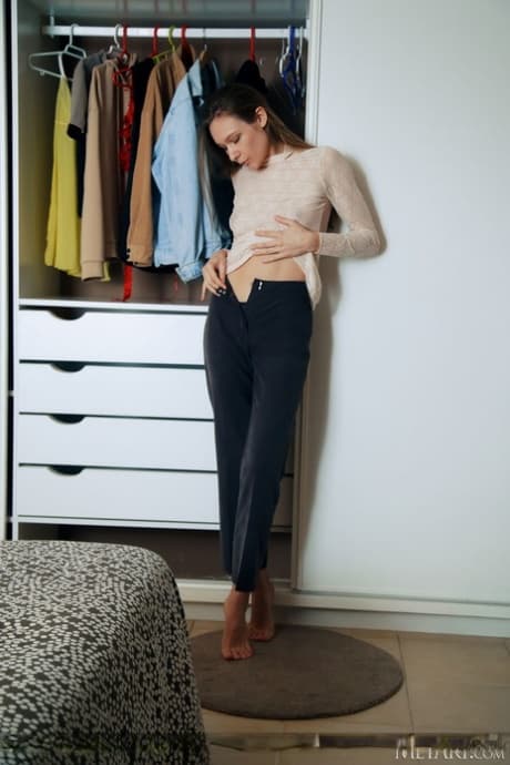 Leggy teen Mirabella disrobes in her bedroom for a nude solo shoot