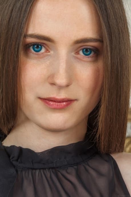 Blue eyed teen Nessie flaunts her nice tits and shaved pussy on a bed