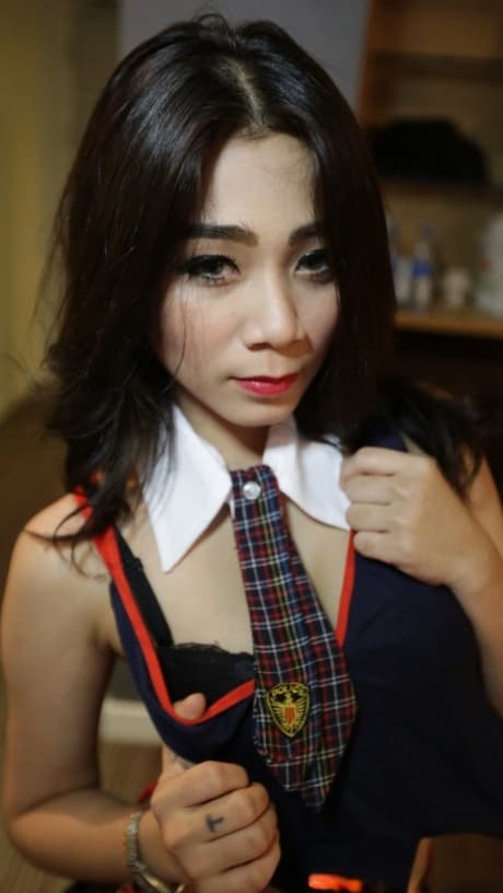 Petite Asian girl An C poses, strips and shares a dick with her girlfriend